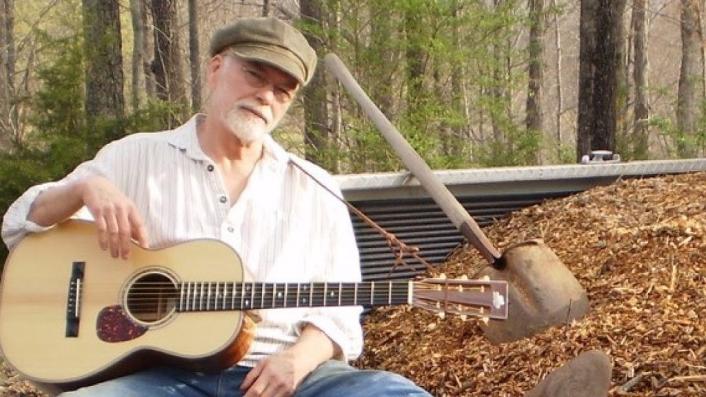 Bat McGrath posing with Guitar